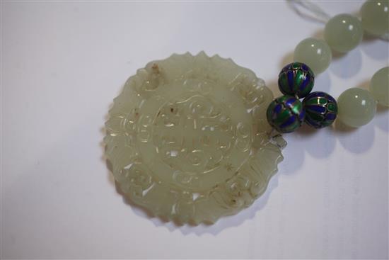 A celadon jade and two colour enamel bead necklace with carved jade pendant, 32in.